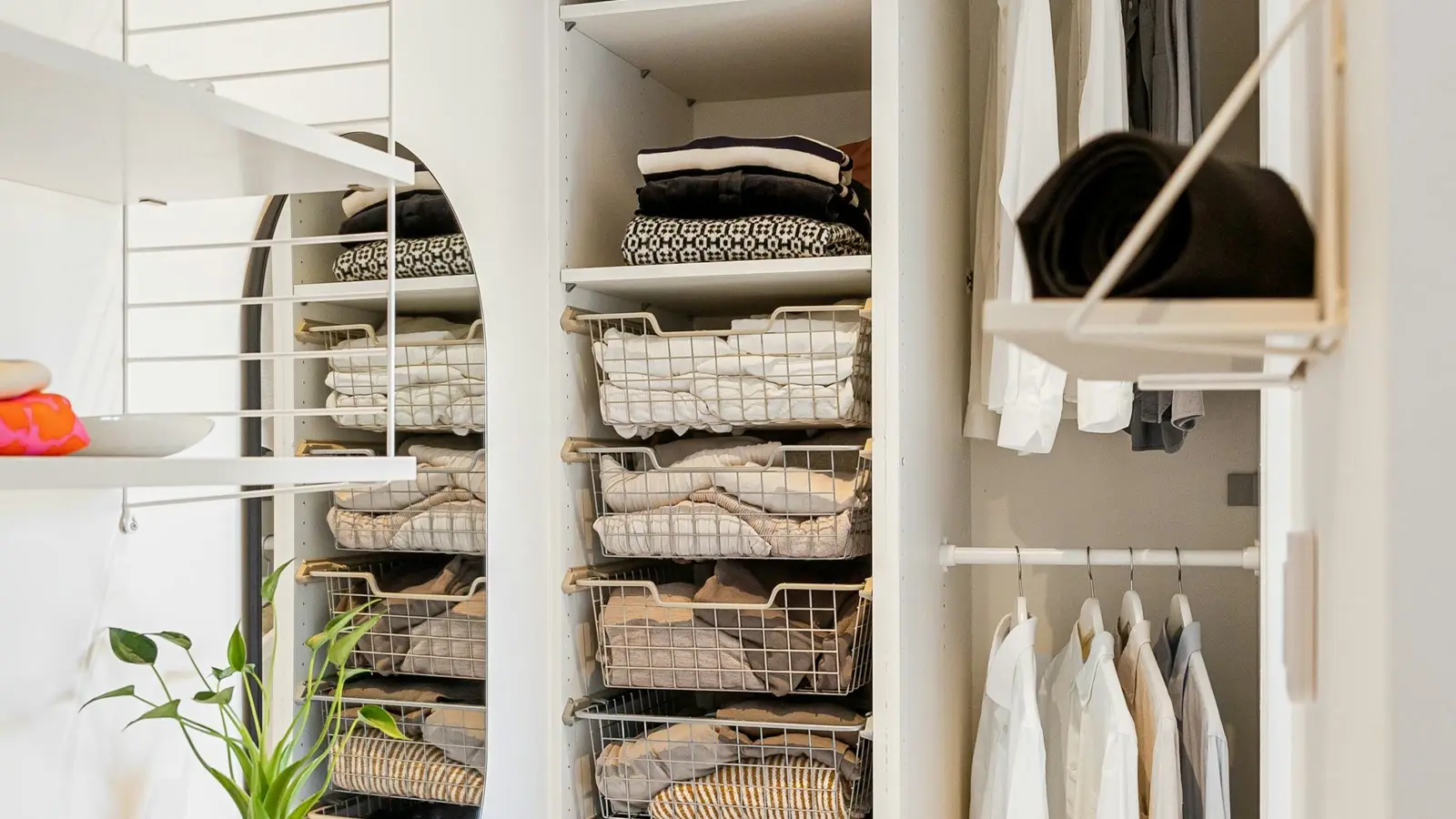 A floor-to-ceiling closet with matching hangers, folded stacks, and wire baskets. Styling reference, not a Fort Smith job photo.